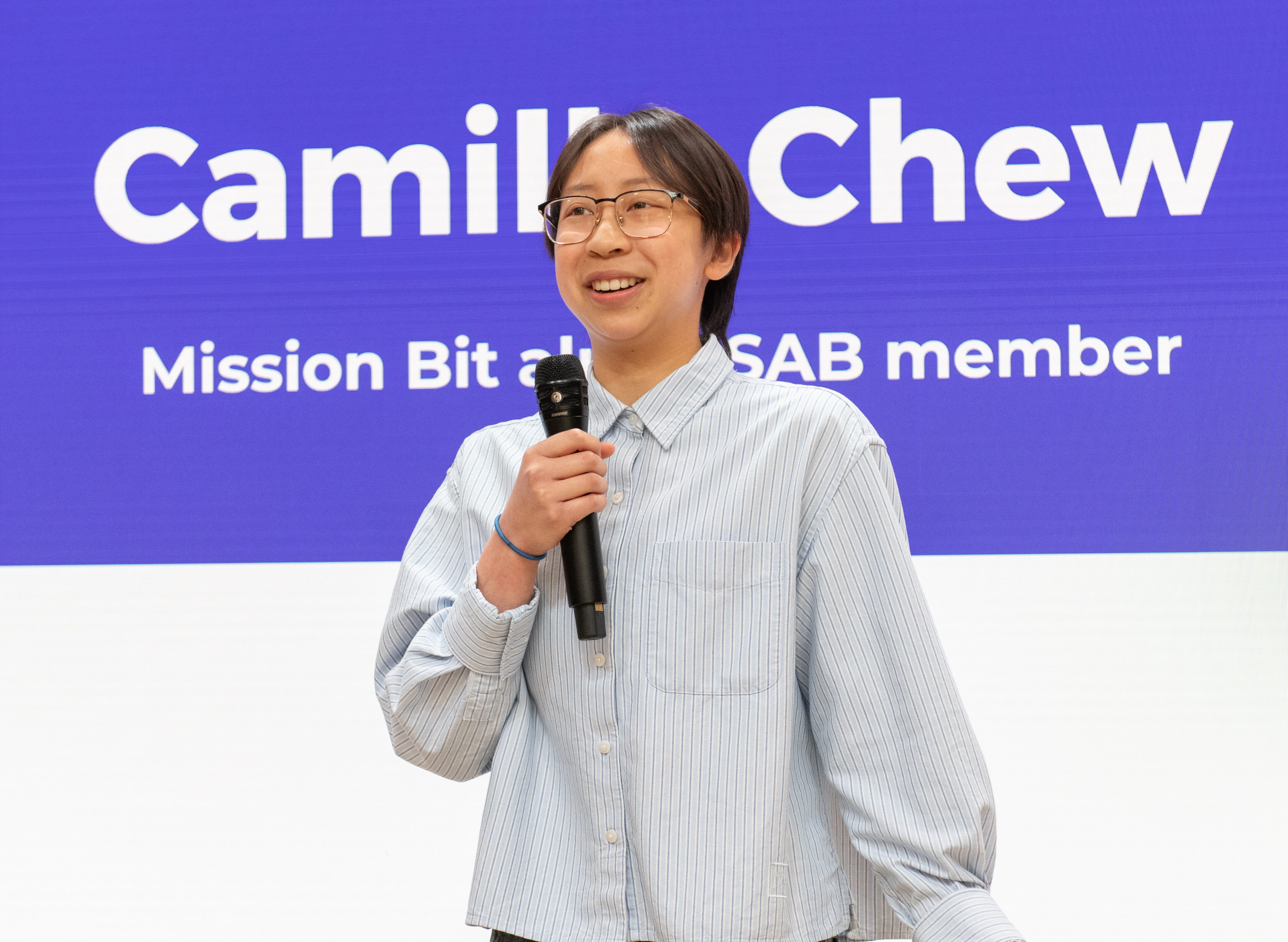 Student ambassador presenting during Mission Bit Demo Day, where students showcase coding and technology projects.