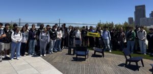 snapchat field trip 1 - Mission Bit Mission Bit students gather for a rooftop group photo at Snap’s San Francisco office, with the Bay Bridge behind them.